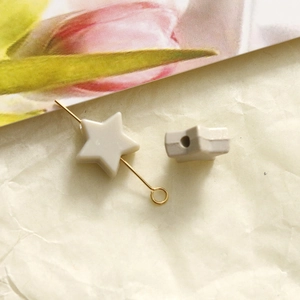 Macro detail of cream star acrylic beads showing 10mm hole for DIY jewelry making