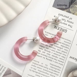 Close-up of pink translucent C-shape resin earrings with S925 silver needles and pearls