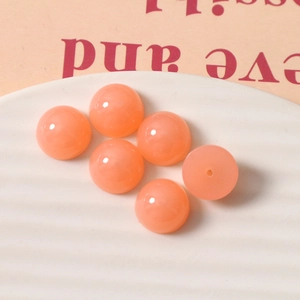Close-up of 14mm peach resin jelly cabochons for DIY earring and jewelry making