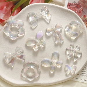 Aurora iridescent resin flower and bow charms for DIY accessories on white tray