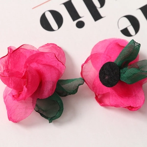 Detail of DIY rose pink chiffon fabric flower with green leaves for hair accessories