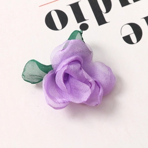 Detail of handmade purple organza rose with green leaves for DIY hair accessories