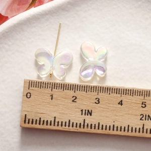 Close-up of 1.5cm iridescent resin butterfly charms for DIY jewelry making