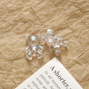 Close-up of translucent aurora resin bear charms for DIY nail art and jewelry