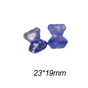 Detailed view of two blue resin bear charms with glitter flakes measuring 23x19mm