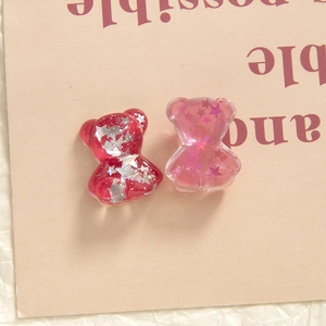 Detail of cute bear resin charms with sparkling star sequins for DIY jewelry and accessories
