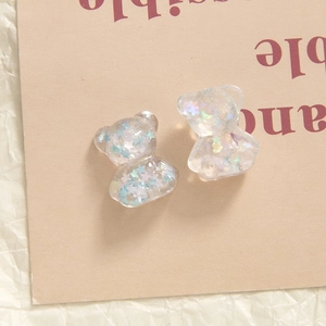 Macro detail of transparent resin bears with glitter star sequins for DIY accessories