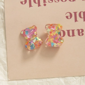 Macro detail of resin bear charms with colorful glitter stars for DIY phone cases