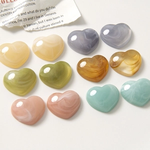 Flat lay of colorful marble textured resin heart charms for DIY jewelry and hair accessories