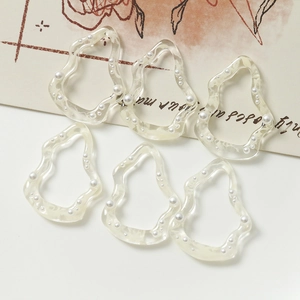 Detalle de seis accesorios de resina DIY irregulares con perlas incrustadas y textura única