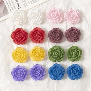Macro shot of 16 vintage cracked paint resin roses for DIY jewelry and hair accessories