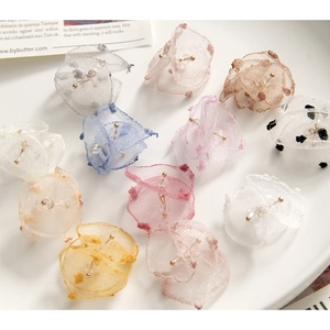 Detailed macro of layered organza flower petals with flocking dots for DIY jewelry