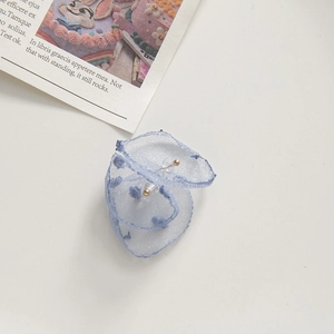 Detail of light blue mesh fabric flower with golden beads for DIY earring jewelry making