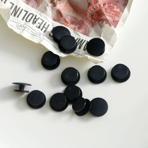Macro shot of black plastic shoe charm button bases for DIY acrylic clog decorations