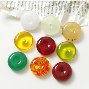 Macro view of 20mm assorted resin charms with jade-like finish and donut shape