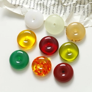 Close-up of polished 20mm round resin stone pendants in multiple vibrant colors for DIY