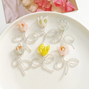 Macro shot of colorful woven tulip beads in a white bowl for DIY earring jewelry making