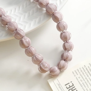 Macro detail of lavender Lily of the Valley glass beads with elegant ribbed texture