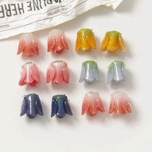 Macro shot of 12 gradient acrylic flower pendants with glitter dots for DIY crafts