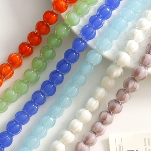 Translucent pumpkin-shaped glass beads in various colors for DIY jewelry making