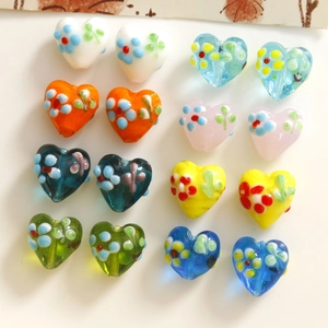 Macro detail of heart shaped glass beads with floral patterns for jewelry making