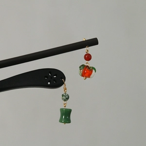 Detailed close-up of handmade Chinese style jade beads and persimmon glass charms