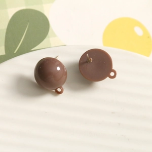 Detailed macro view of dark coffee resin earring studs with metal loop connectors