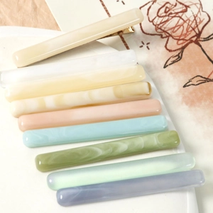 Set of 10 colorful marbled resin long hair clips with gold metal base on white plate