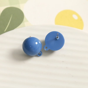 Macro shot of blue resin round stud earring with metal pin and small DIY hanging loop