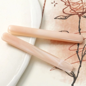 Close-up of elegant marble texture resin hair clips on white decorative plate