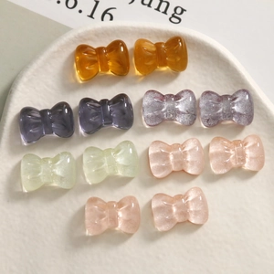 Close-up of sparkling resin glitter bow charms for DIY jewelry and hair accessories