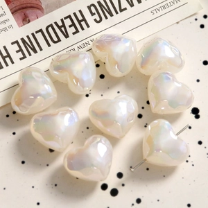 Detailed view of iridescent heart pearls with pre-drilled holes for jewelry DIY
