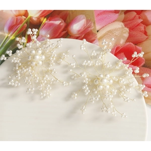 Handcrafted pearl and gold wire flower hair accessories on a white plate with tulips