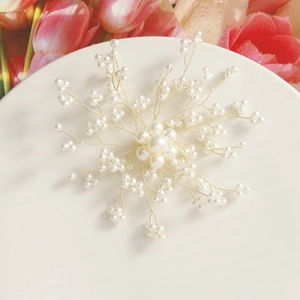 Detail of handmade gold wire woven flower with faux pearls for hair accessories