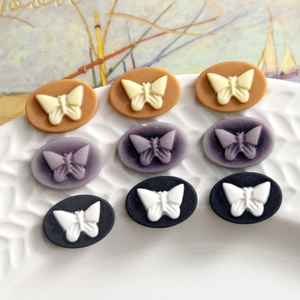 Detailed view of resin butterfly relief oval charms for DIY jewelry and crafts