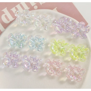 Iridescent resin flower charms in various pastel colors for DIY jewelry and hair accessories