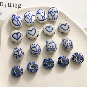 Handcrafted blue and white ceramic beads with heart and floral patterns for DIY jewelry making