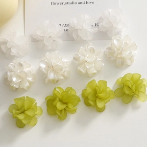 Detailed macro view of 3D matte acrylic flower charms for DIY jewelry and hair accessories