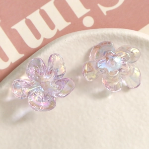 Macro detail of transparent iridescent resin flower charms with polarising luster