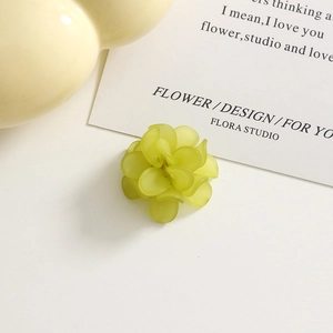 Close-up of matte grass green acrylic flower charms with frosted petal details for DIY