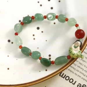 Vue macro de perles en jade naturel et pendentif en céramique sur plat vintage