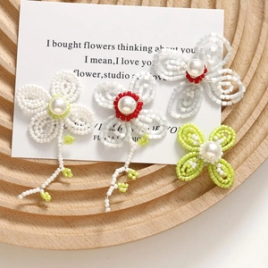 Handmade woven flower earrings with large white pearls in lime green and white colors