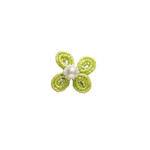 Handmade woven light green flower earring with a central white pearl on a white background