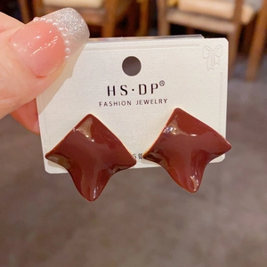 Detail of dark red geometric resin earrings with S925 silver needles on display card