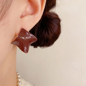 Detail of dark coffee glaze geometric earring on model with vintage aesthetic style