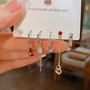 Detail of red gourd and pearl earring set on display card with silver chain and zircons