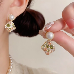 Elegant gold earrings with round white pearls and multicolored zircon diamond pendants