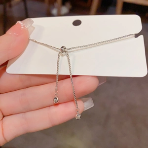 Detail of silver adjustable box chain bracelet with slider clasp and polished beads