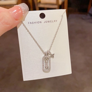 Detailed close-up of a silver pavé star pendant on a twist chain with display card