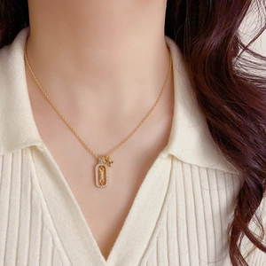 French style gold square necklace with sparkling zircon star pendant shown on model